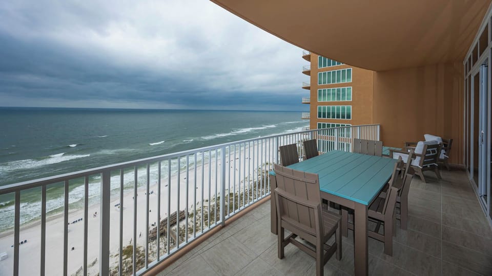 Relax on the beachfront balcony, feel the gulf breeze and listen to waves while reclining in cushioned chairs