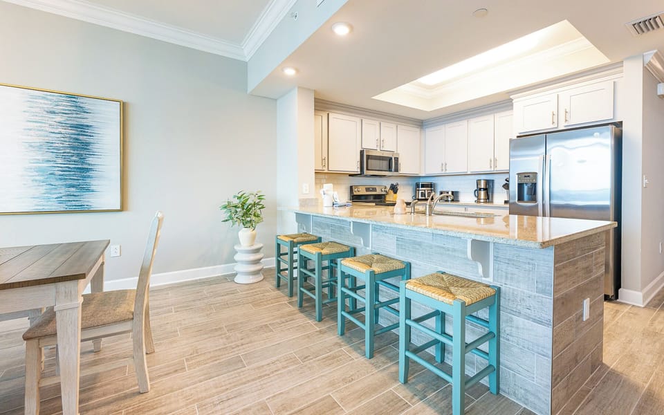 Sip your morning coffee at the breakfast bar and get ready for a beach day in this stylish space