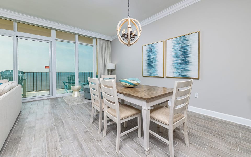 Sit at the wooden dining table beneath coastal art and plan your day along the gulf coast