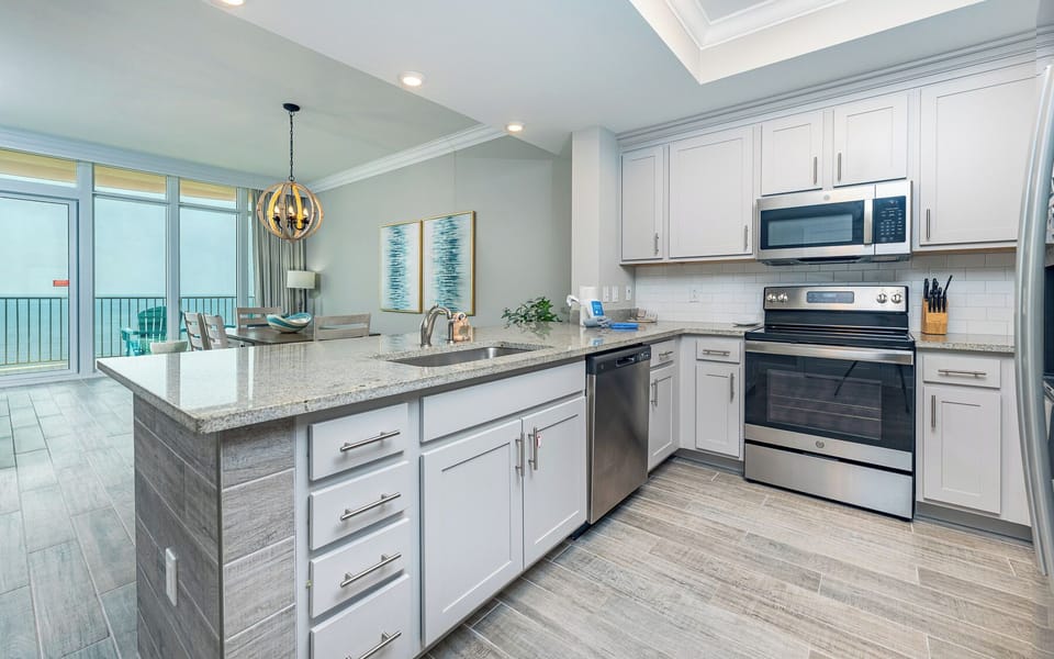 Prepare meals in this kitchen with elegant cabinetry, stainless appliances, and spacious countertops