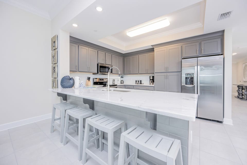 Sit on the counter stools and sip your morning coffee and get ready for a beach day in this stylish space
