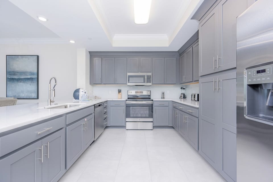 Prepare meals in this kitchen with elegant cabinetry, stainless appliances, and spacious countertops