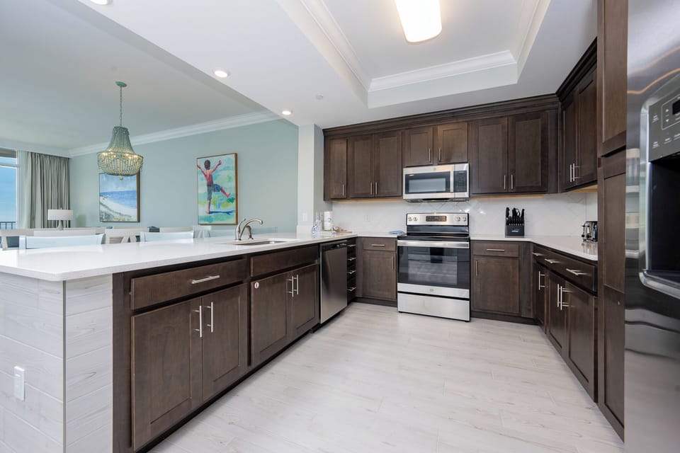 Prepare meals in this kitchen with elegant cabinetry, stainless appliances, and spacious countertops