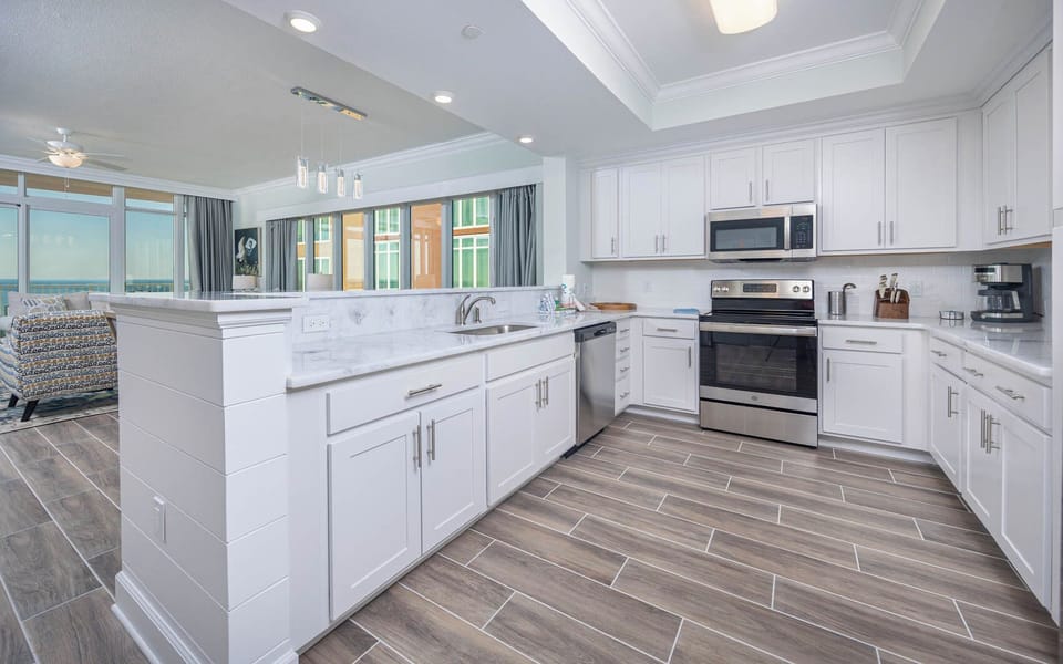 Prepare meals in this kitchen with elegant cabinetry, stainless appliances, and spacious countertops