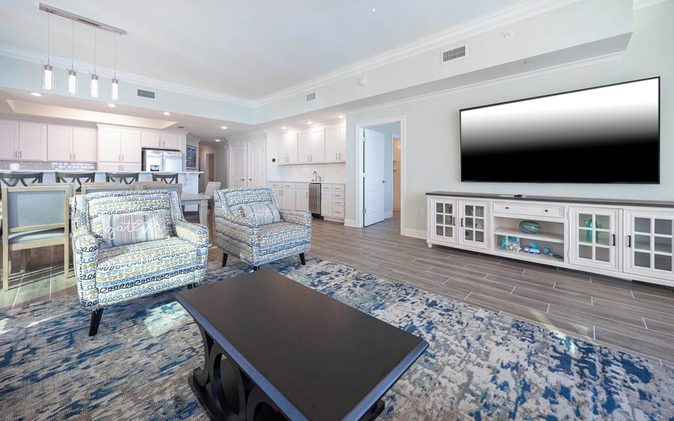 Relax on the cozy sofa in this inviting family room with a good movie after a day at the beach