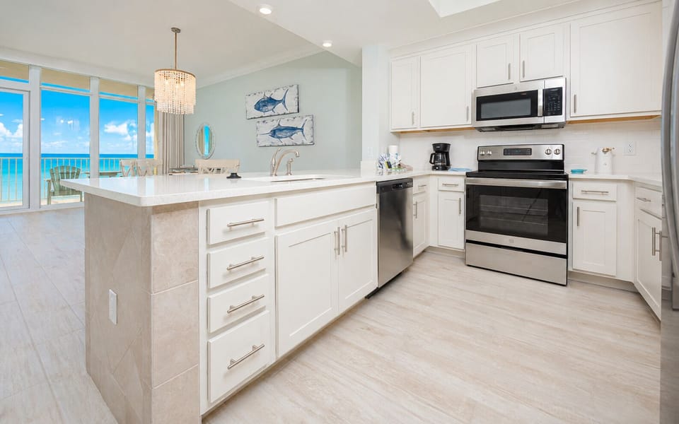 Prepare meals in this kitchen with elegant cabinetry, stainless appliances, and spacious countertops