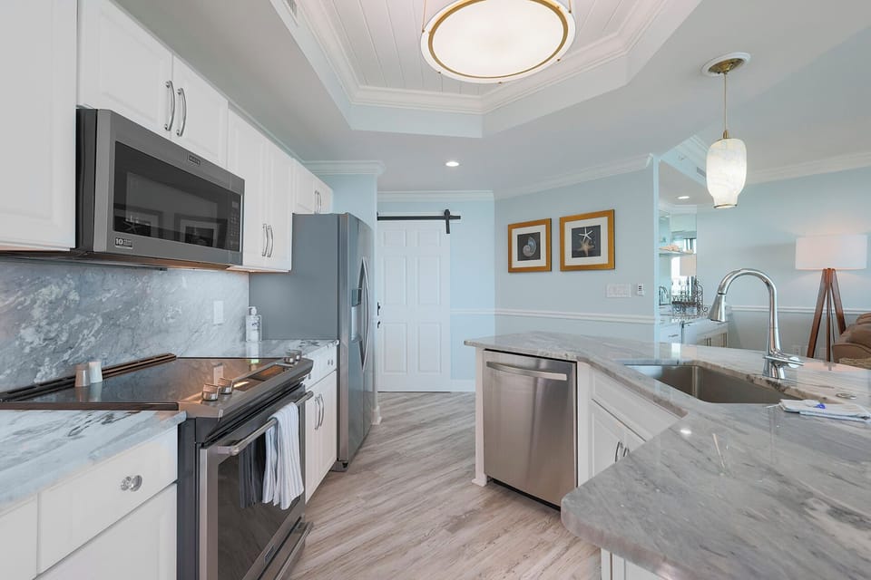 Upgrade your culinary experience in this stylish kitchen with modern stainless appliances and elegant design
