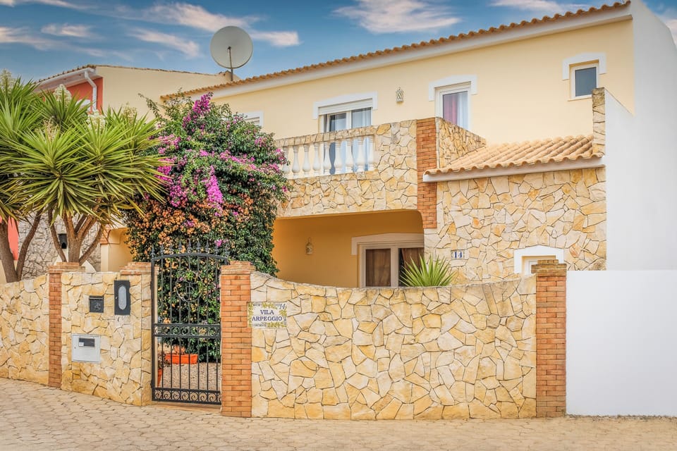 Charming villa exterior with warm stone details and a welcoming entrance
