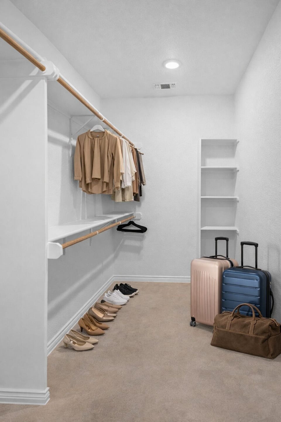 Spacious walk-in closet with plenty of hanging space, built-in shelving, and room to neatly store luggage, shoes, and personal belongings during your stay.