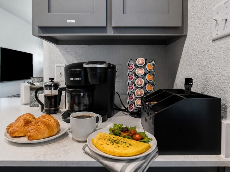Start your morning right with a fully stocked coffee bar featuring a French press, a variety of coffee options, creamers, and sugar—plus all the pots and pans you need to whip up a magnificent breakfast right at home.