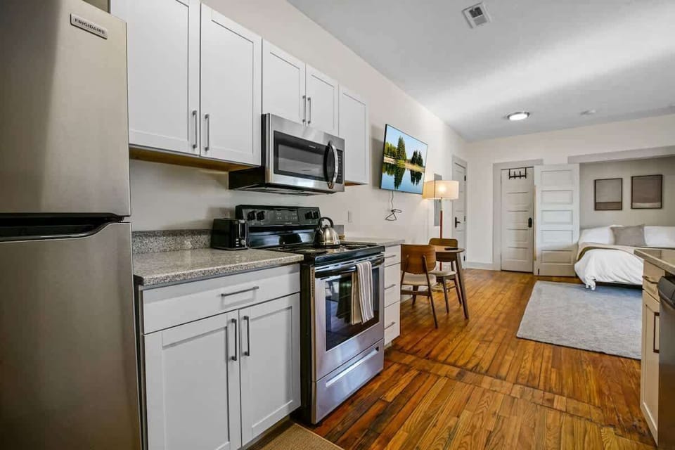 Fully equipped kitchen w/ stainless appliances, white cabinets & plenty of counter space