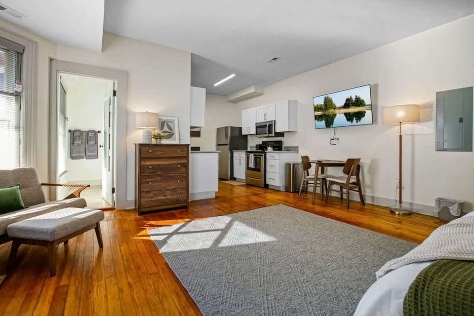 Open-concept studio w/ kitchen, dining nook & living space bathed in natural light
