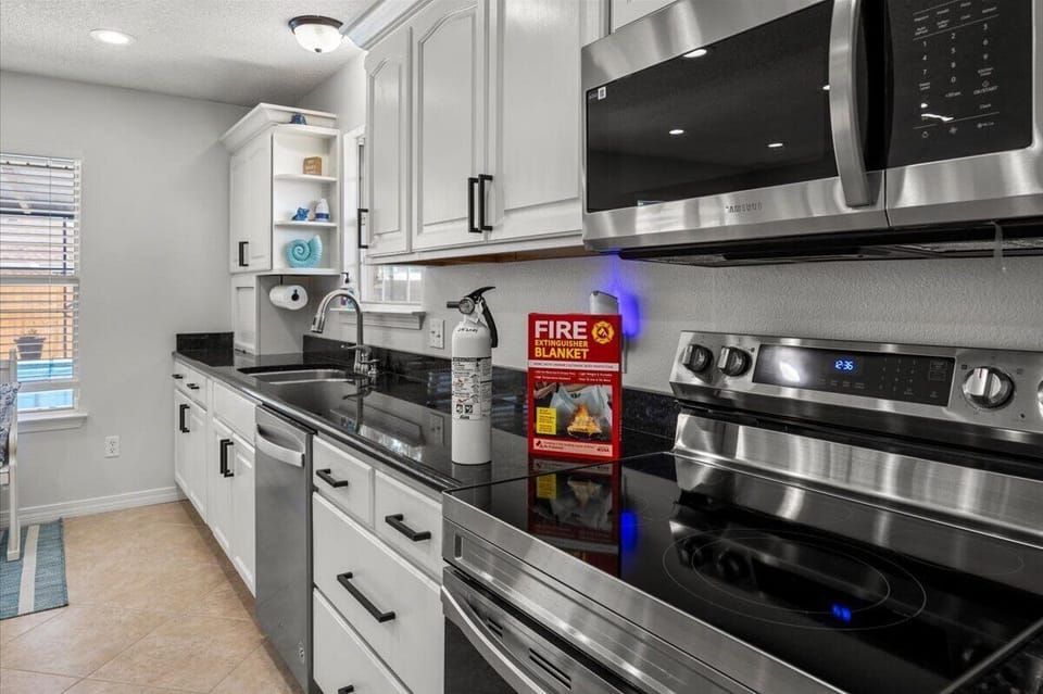 Kitchen equipped with a fire blanket and fire extinguisher.