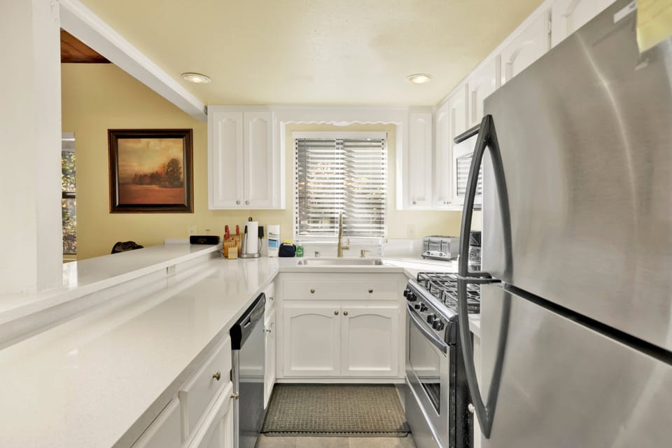 Fully equipped cabin kitchen with ample cabinetry, stove, fridge, microwave, and coffee maker—perfect for cooking meals, morning coffee, and feeling right at home on your stay.