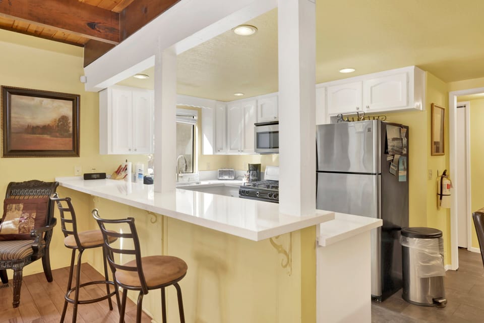 Fully equipped cabin kitchen with ample cabinetry, stove, fridge, microwave, and coffee maker—perfect for cooking meals, morning coffee, and feeling right at home on your stay.