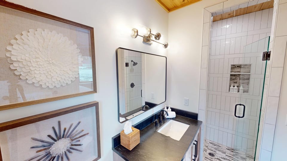 Your spa-like bathroom features a sleek glass shower and elegant vanity, perfect for unwinding after your adventures.