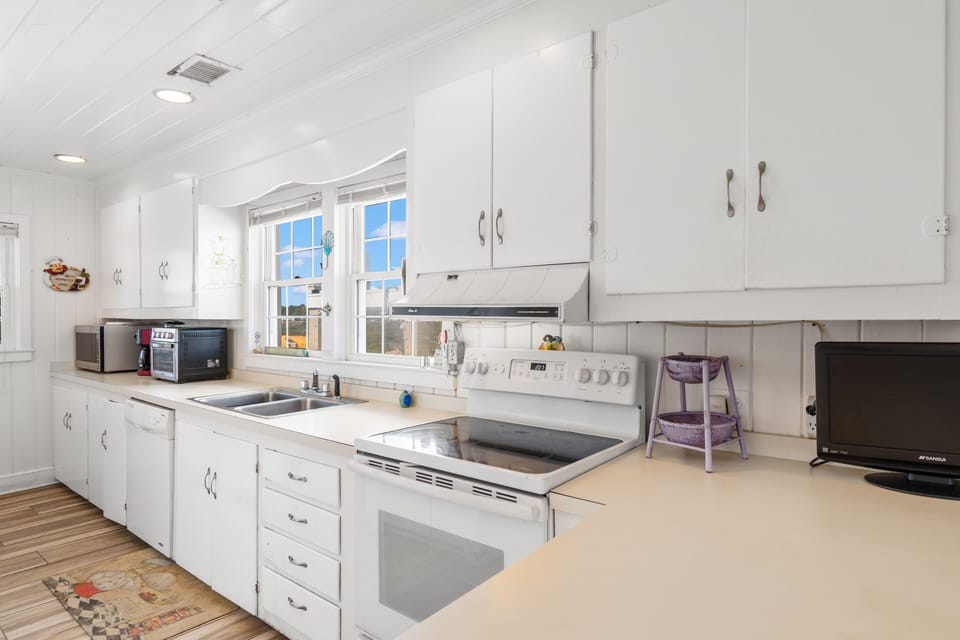 Your bright, fully-equipped kitchen awaits with modern appliances and ample counter space for preparing meals during your stay.