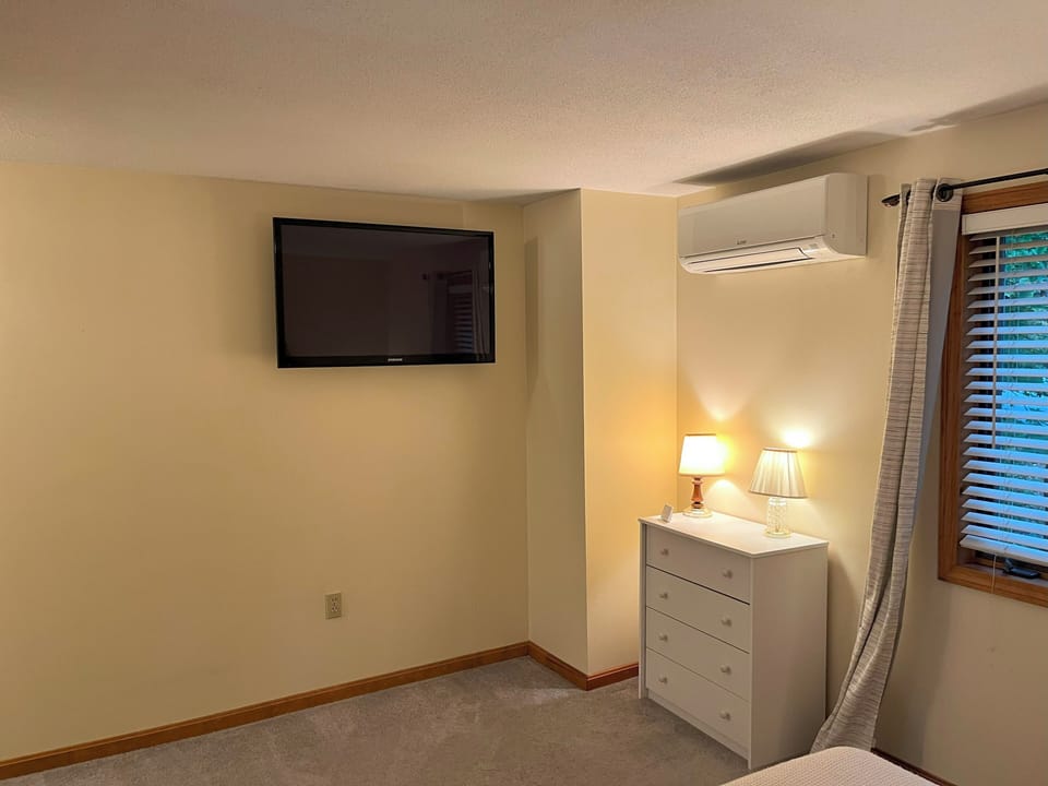 TV mounted in twin bedroom