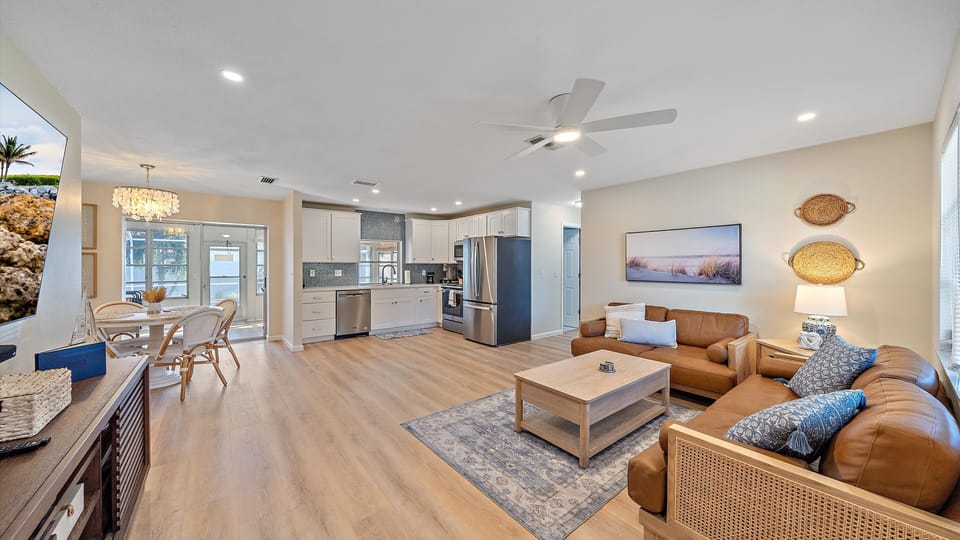 Enjoy the seamless flow of the open living, dining, and brand-new kitchen space, creating a perfect environment for family connection during your Florida vacation.