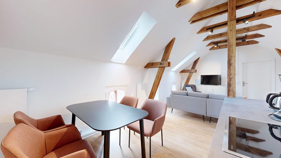 Spacious living area with dining table in Apartment 11 (1)