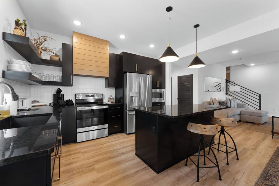 Large gourmet stocked kitchen with island and large dining area for cooking and sharing meals together