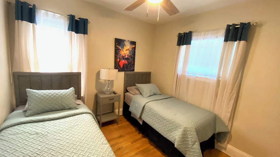 Two more single beds with a television.