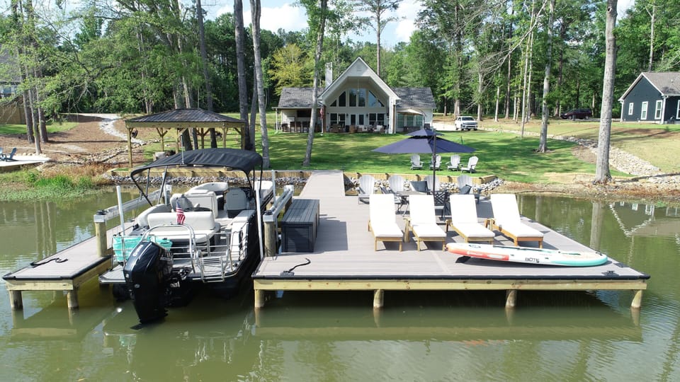 Lakeside view of our dock, back yard, and entertainment areas.