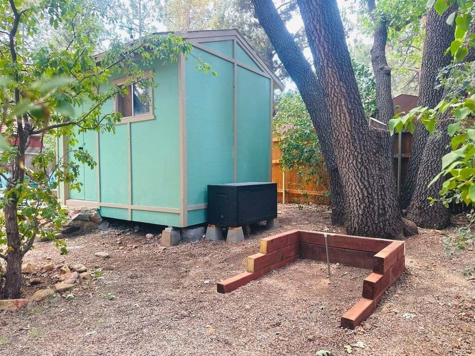 Private outdoor hot tub, surrounded by tall pines, perfect for relaxing under the trees after a day of adventure—enjoy peaceful forest views, fresh air, and a truly rejuvenating stay.