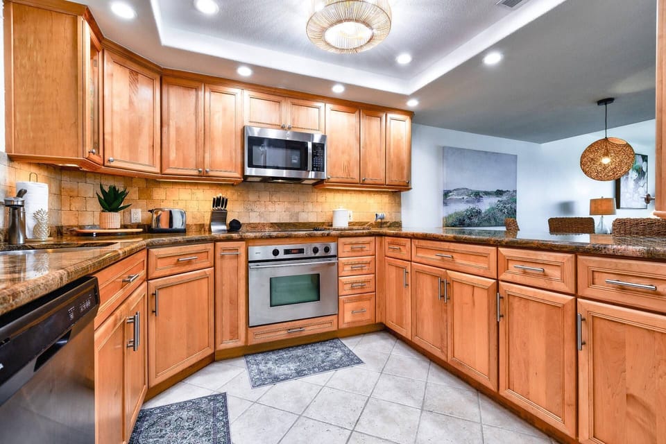 The updated kitchen features stainless steel appliances & granite countertops, combining style & functionality for a perfect cooking experience.
