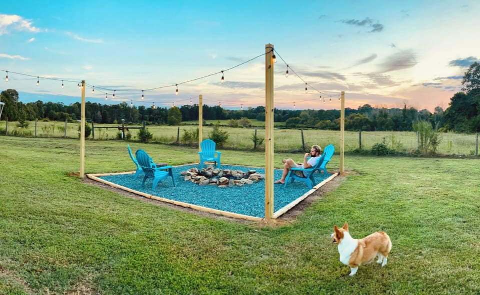 Large fire pit, in fenced in backyard overlooking neighboring lake & horses