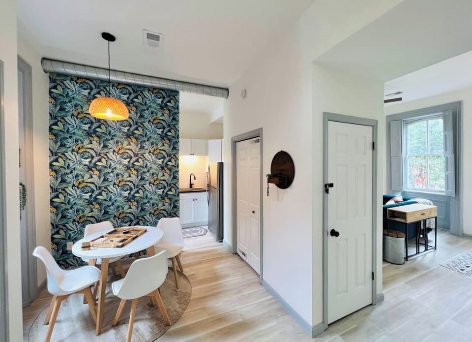 As you enter the apartment door, you see the kitchen and living room spaces.
