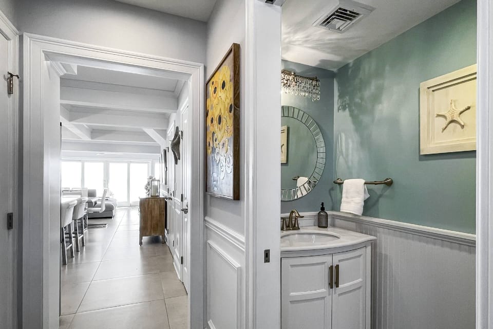 Powder room on the main floor at the entrance of the home for guest convenience
