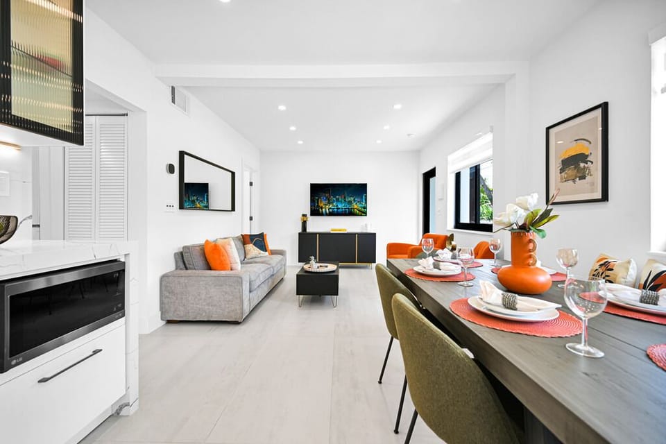 Stylish open living space with vibrant accents and cozy dining area.