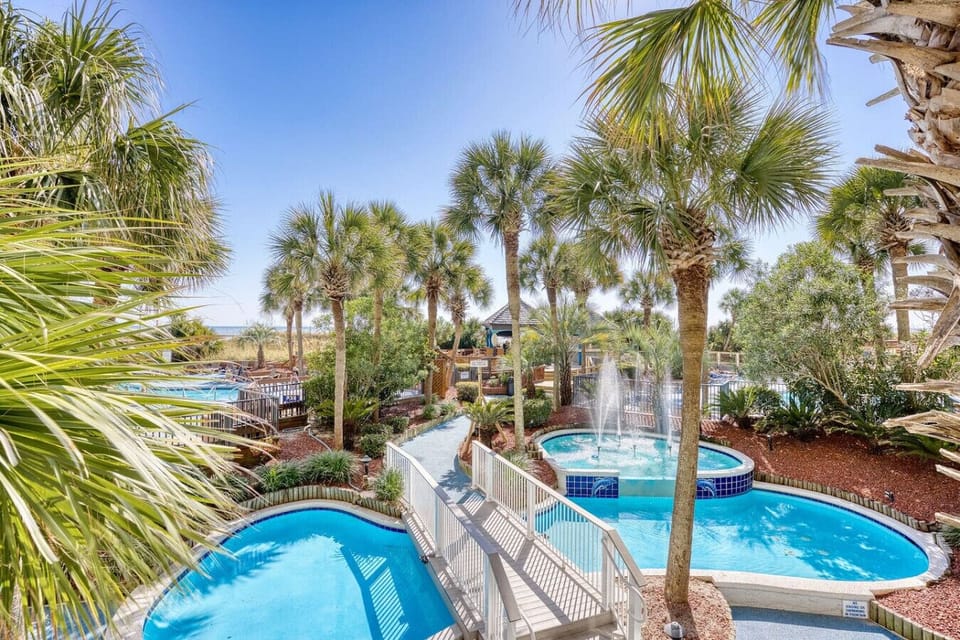 Palm-lined pool area with fountains that light up at night, creating a tropical vibe. Relax in the hot tubs, float the lazy river, or enjoy the resort`s stunning ambiance under the stars.