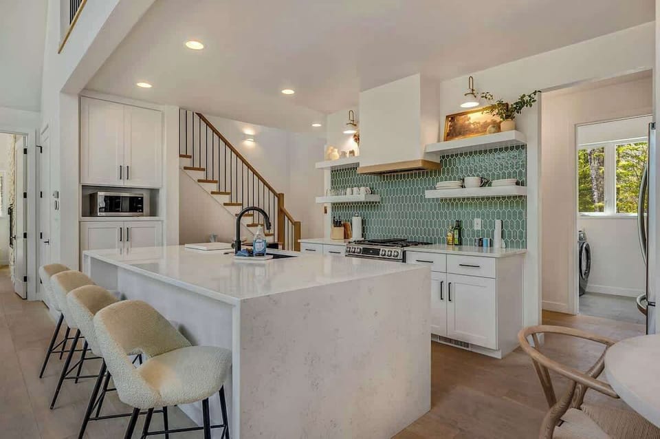 The fully equipped kitchen is a chef’s dream, featuring modern appliances and plenty of counter space for preparing meals