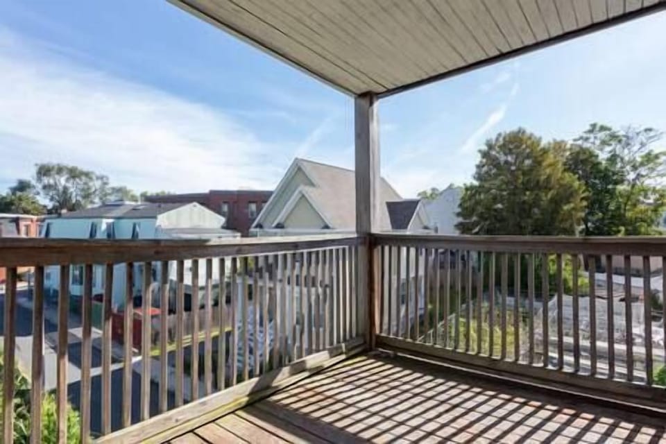 A stunning balcony with skyline views above a public garden.