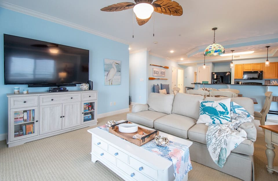 Relax in this spacious living room with comfortable seating, entertainment, and an open-concept layout