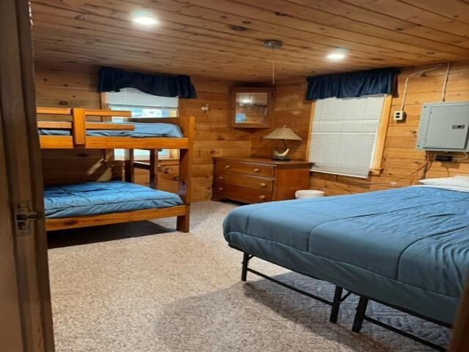 Bedroom with double bed and twin bunk beds