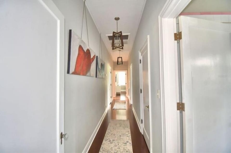 Grand hallway connects the three bedrooms and hall bath