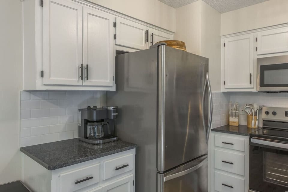 A stylish, fully equipped kitchen with modern appliances and ample counter space, perfect for cooking meals or enjoying a quick breakfast. Thoughtfully designed for convenience and comfort.