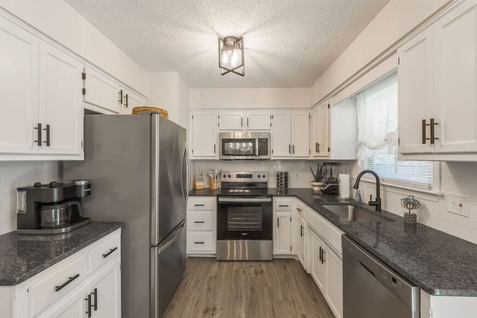 A stylish, fully equipped kitchen with modern appliances and ample counter space, perfect for cooking meals or enjoying a quick breakfast. Thoughtfully designed for convenience and comfort.