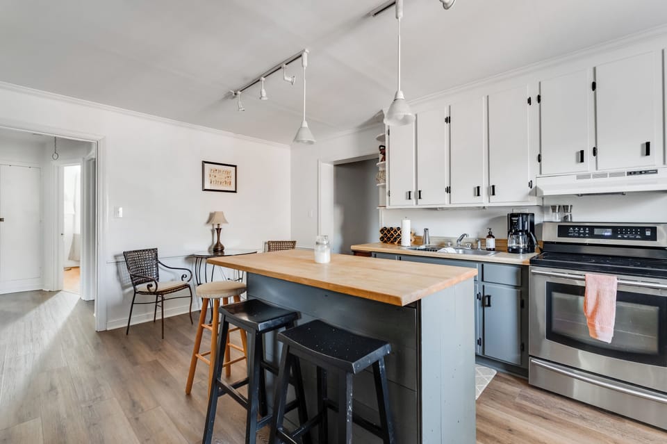 Kitchen: Modern design meets function with sleek appliances and inviting dining space!