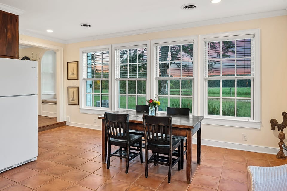 Dining Area: Bright and airy space perfect for meals with views of lush green landscapes!