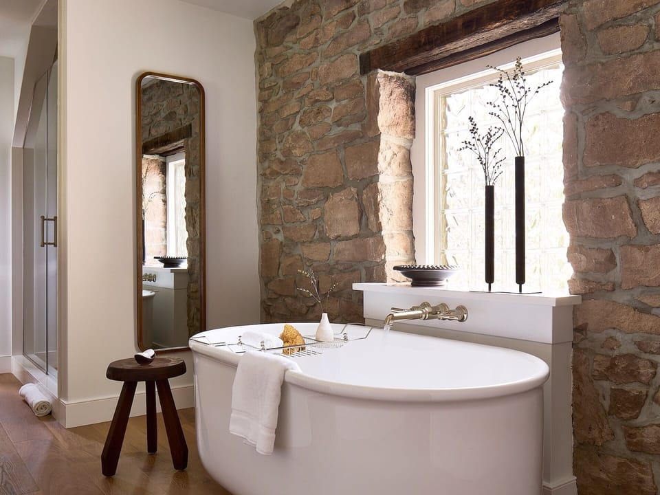Deluxe Room w/Fire Place & Soaking Tub | Bathroom | Deep soaking tub, rainfall showerhead, designer toiletries, hair dryer