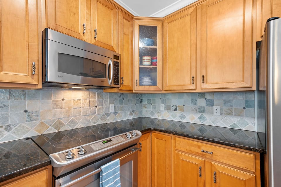 Stove and microwave with plenty of cabinet space and filled with amenities 