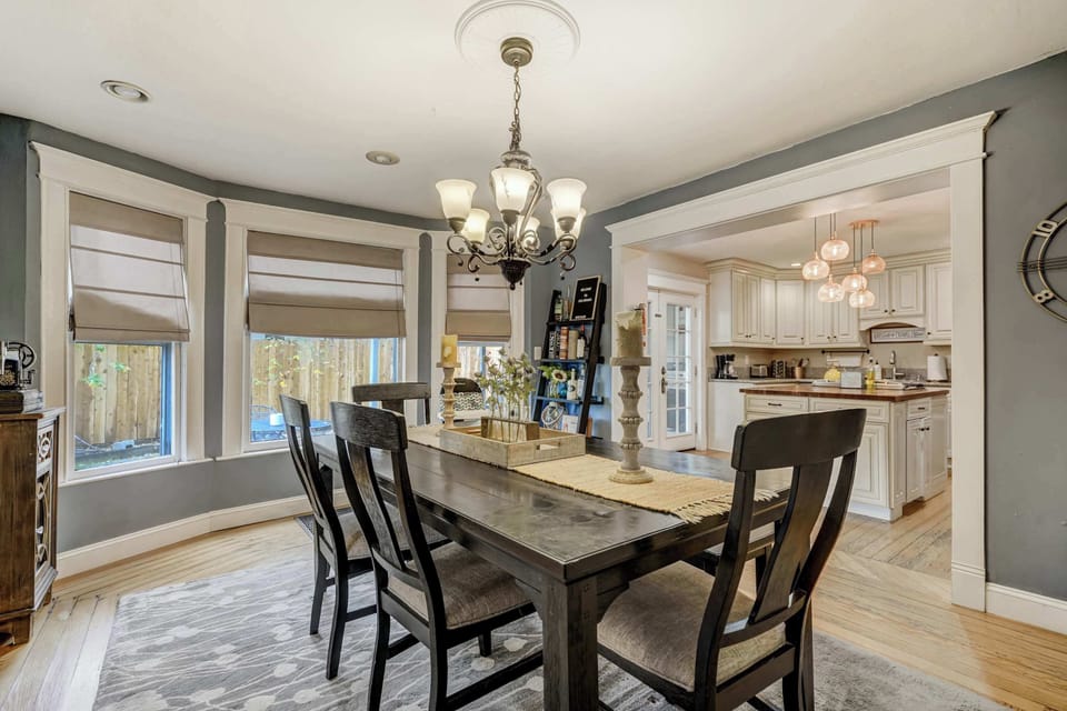 Bright and airy dining room with stylish seating and large windows, ideal for enjoying meals with family and friends.