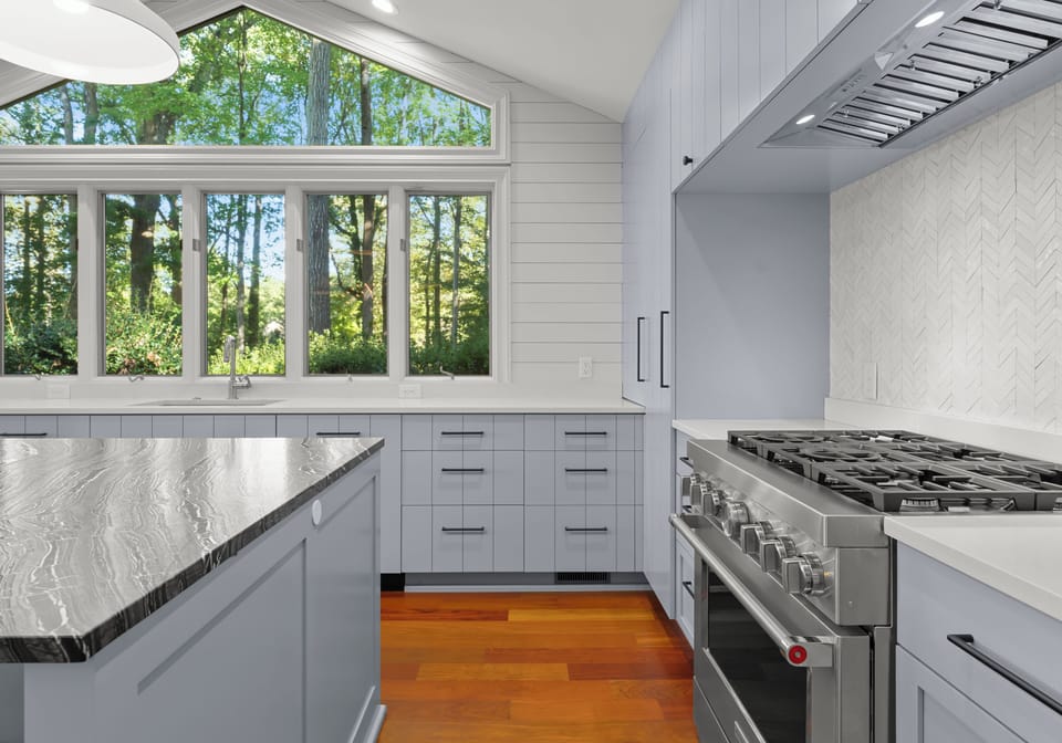 Fully stocked gourmet kitchen with integrated appliances and bar seating for 4. 