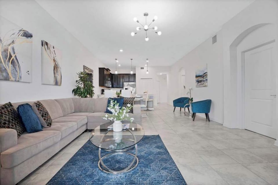 Spacious living area with modern furnishings and an open kitchen layout.