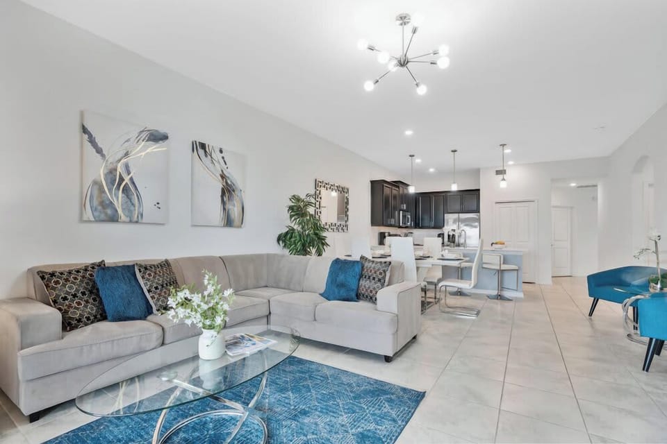 Modern open-concept living area with a spacious sectional and dining space.
