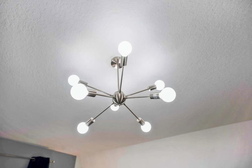 Modern ceiling light fixture with multiple bulbs providing bright illumination.